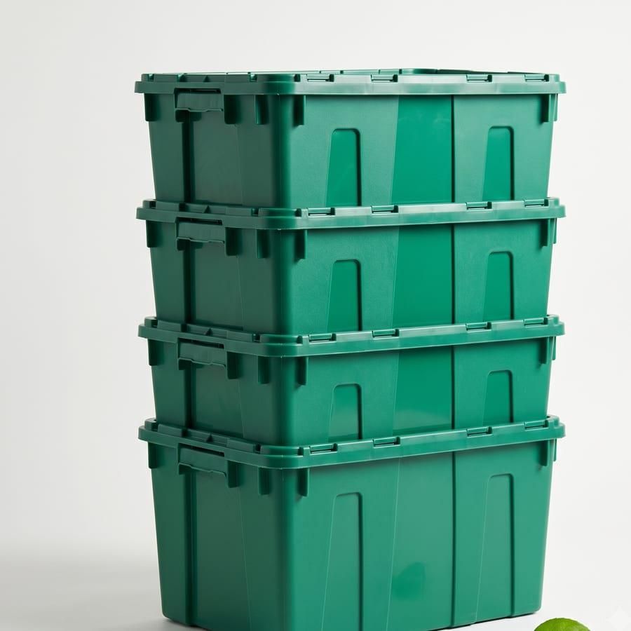 A stack of freshly cleaned green moving crates ready to be reused, not binned